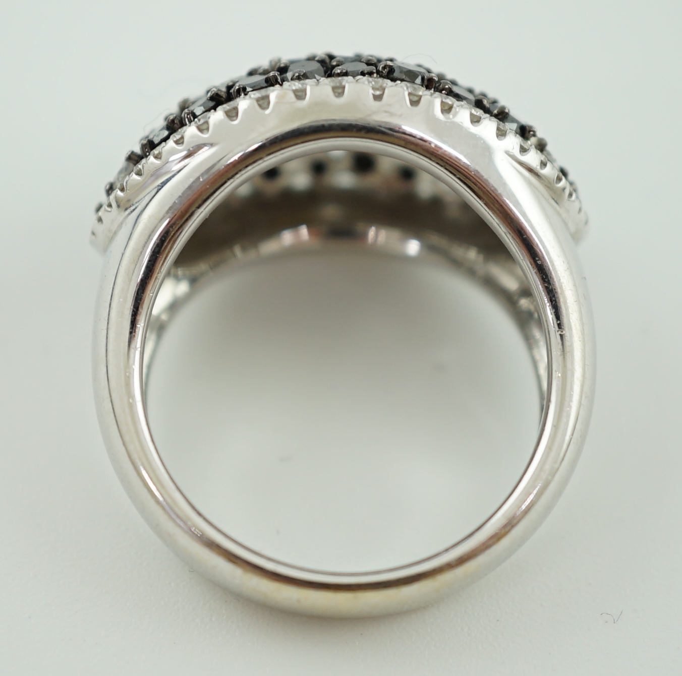A modern pair of 750 white gold and two colour diamond cluster dress ring